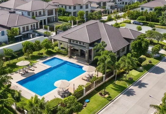 The clubhouse and pool from above, beside the main road