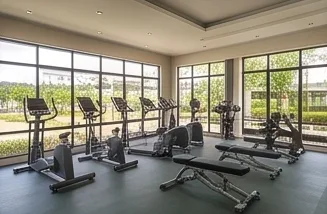 The fitness centre with its machines by the windows