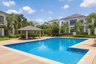 The swimming pool with its cabana and the homes behind it